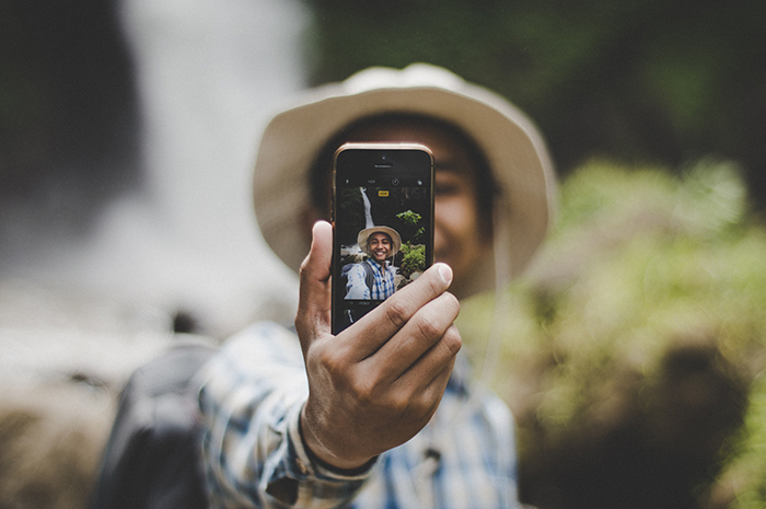 A man taking a selfie with a smartphone