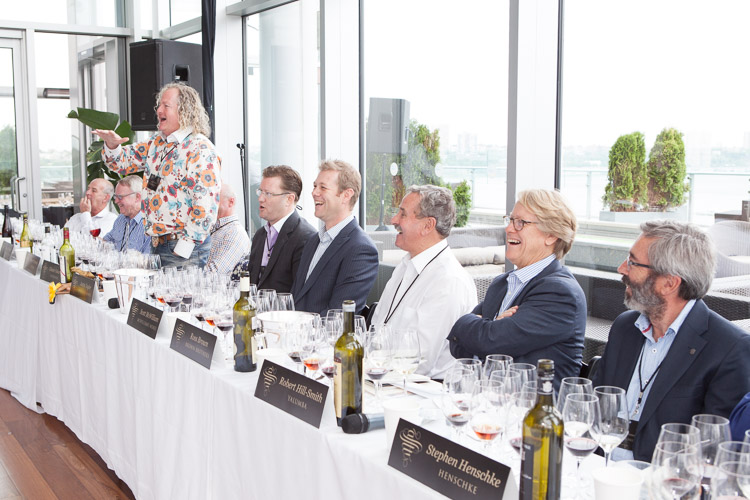 photographer captures the expressions on the faces of the judges at the wine tasting event