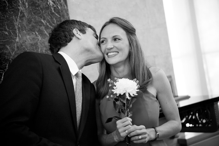 photographer captures the moment when the man kisses the woman